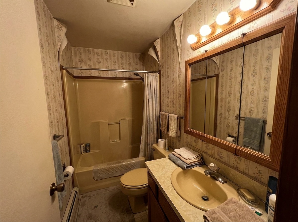 Dated almond-colored hall bathroom before remodeling